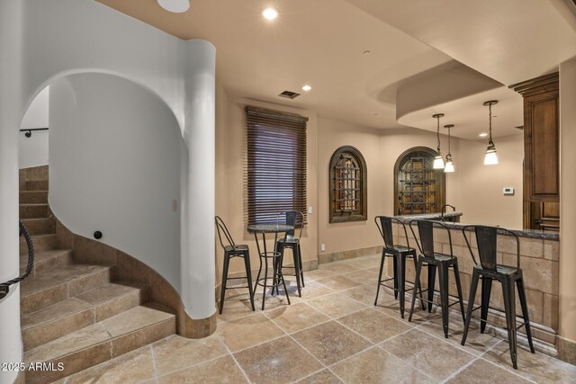 6852 E Fanfol Dr, Paradise Valley, AZ 85253 - bar with stairs, arched walkways, decorative light fixtures, visible vents, and recessed lighting