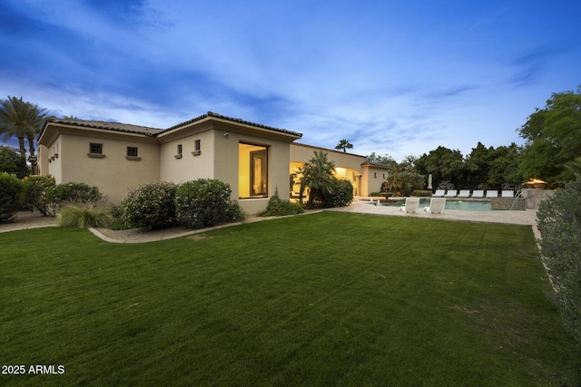 6852 E Fanfol Dr, Paradise Valley, AZ 85253 - rear view of house with an outdoor pool, a tiled roof, a yard, and stucco siding