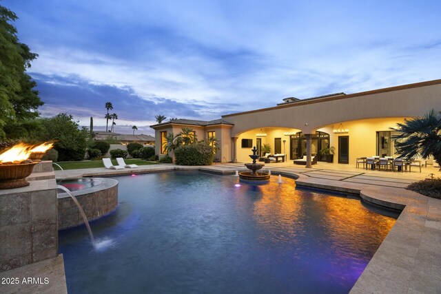6852 E Fanfol Dr, Paradise Valley, AZ 85253 - pool at dusk featuring a patio area