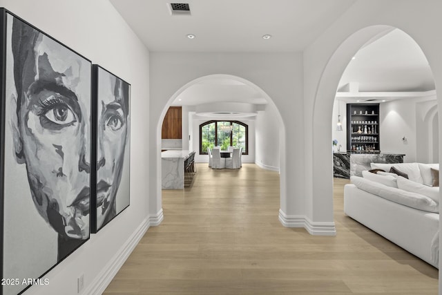 6852 E Fanfol Dr, Paradise Valley, AZ 85253 - hallway featuring recessed lighting, light wood finished floors, visible vents, arched walkways, and baseboards