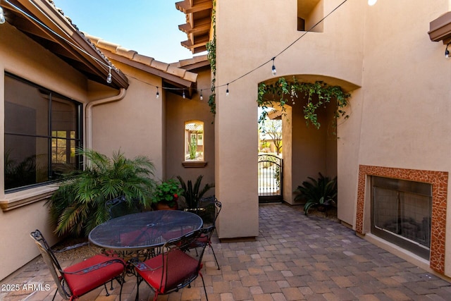 view of patio / terrace with outdoor dining space and a gate