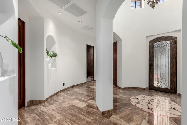 foyer featuring marble finish floor, baseboards, visible vents, and recessed lighting