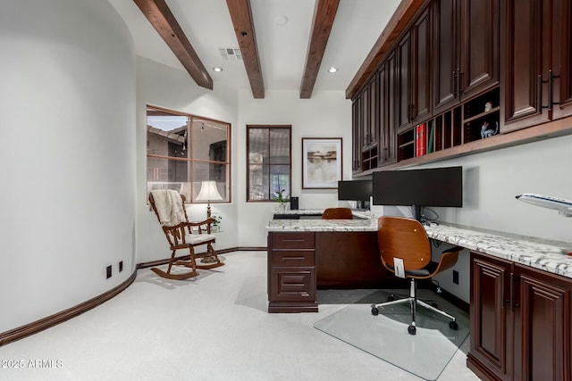 home office featuring beam ceiling, built in desk, light colored carpet, visible vents, and baseboards