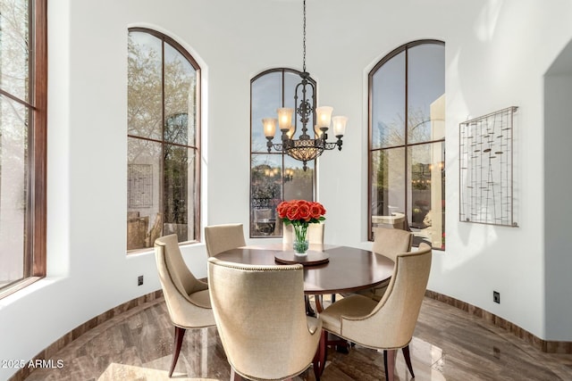 dining area with baseboards and a chandelier