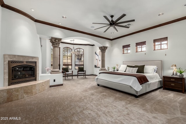 bedroom with carpet floors, arched walkways, visible vents, and ornate columns