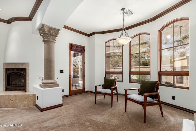 sitting room with carpet floors, visible vents, and ornate columns