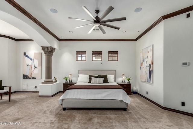 carpeted bedroom with ornate columns, baseboards, arched walkways, and crown molding