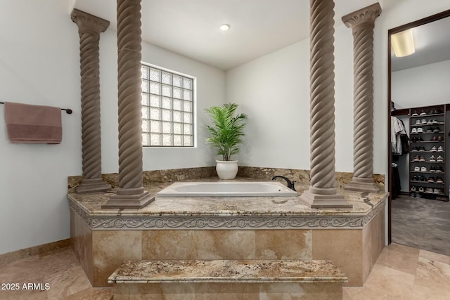 full bath featuring ornate columns and a bath