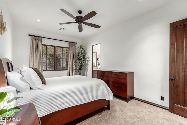 bedroom featuring baseboards, visible vents, a ceiling fan, and light colored carpet