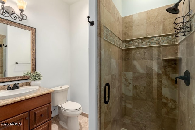 bathroom featuring baseboards, a shower stall, toilet, and vanity