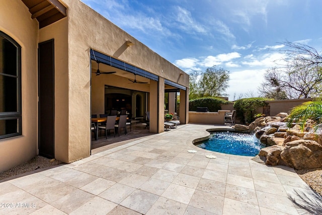 view of swimming pool with ceiling fan, fence, a fenced in pool, and a patio