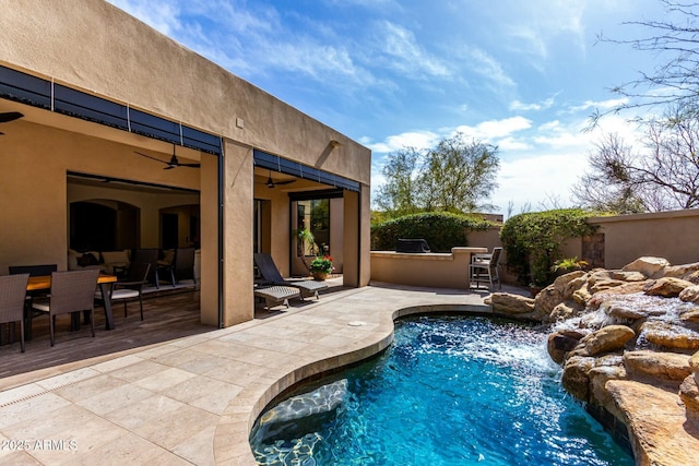 view of pool featuring a patio, fence, a ceiling fan, a fenced in pool, and outdoor dining space