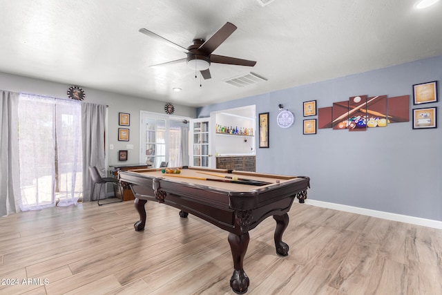 game room with light wood-type flooring, french doors, a textured ceiling, ceiling fan, and billiards