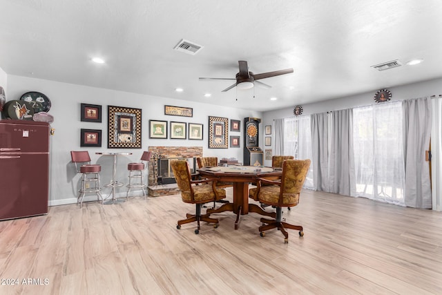 dining area featuring light wood-type flooring and ceiling fan