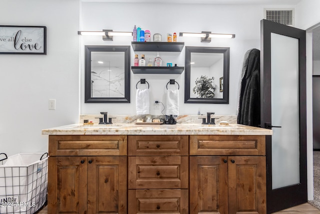 bathroom with vanity and hardwood / wood-style flooring