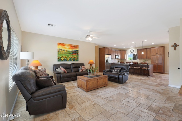 living room featuring sink and ceiling fan