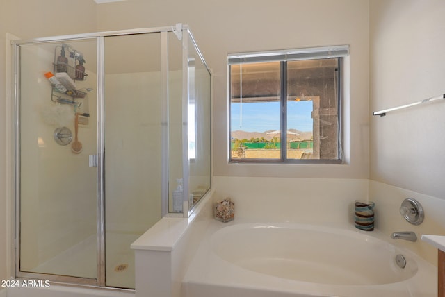 bathroom featuring independent shower and bath