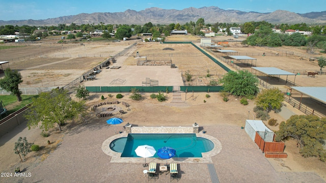 view of pool featuring a mountain view and a patio area