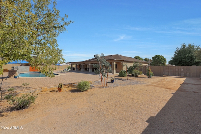 view of front of home featuring a fenced in pool and a patio area