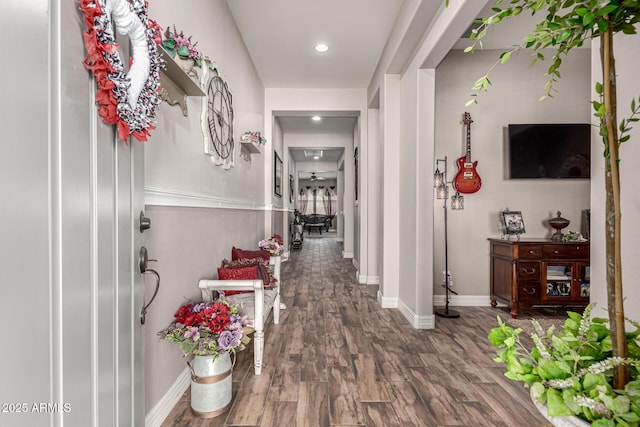 corridor featuring recessed lighting, wood finished floors, and baseboards