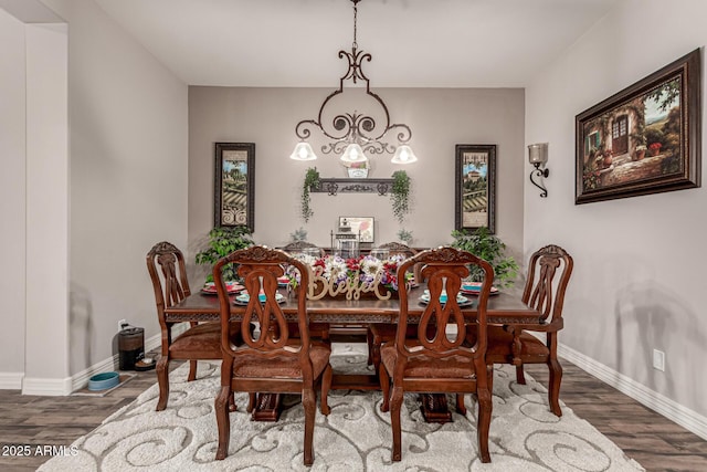 dining area featuring baseboards and wood finished floors