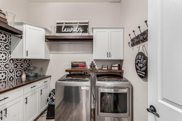 laundry area with washing machine and dryer and cabinet space