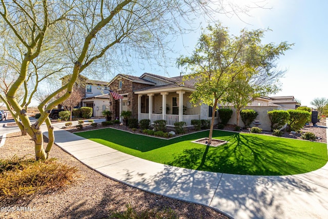 view of front of house featuring a porch, a front yard, stone siding, and stucco siding