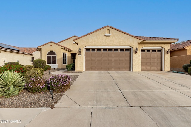 mediterranean / spanish-style home featuring a garage