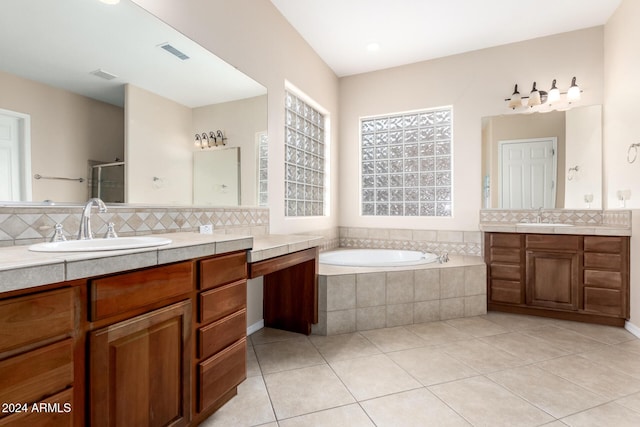 bathroom with separate shower and tub, vanity, decorative backsplash, and tile patterned floors