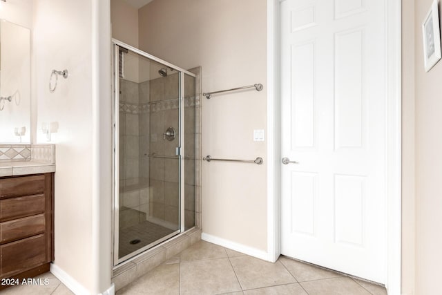 bathroom with vanity, tile patterned flooring, and walk in shower