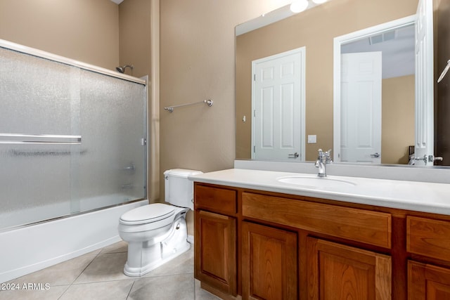 full bathroom with vanity, toilet, shower / bath combination with glass door, and tile patterned floors