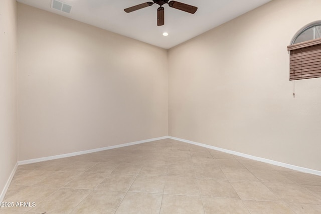 tiled spare room with ceiling fan