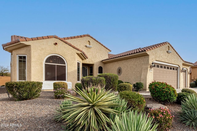 mediterranean / spanish-style home featuring a garage