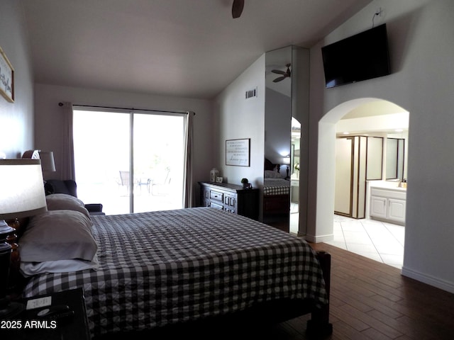 bedroom featuring lofted ceiling, arched walkways, a ceiling fan, access to exterior, and light wood-style floors