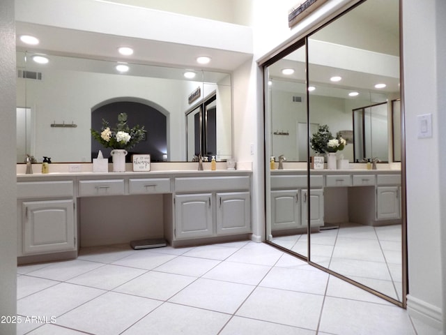 bathroom with double vanity, visible vents, tile patterned floors, a sink, and recessed lighting