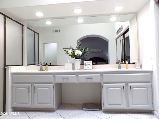 full bathroom with double vanity, a sink, visible vents, and a shower stall