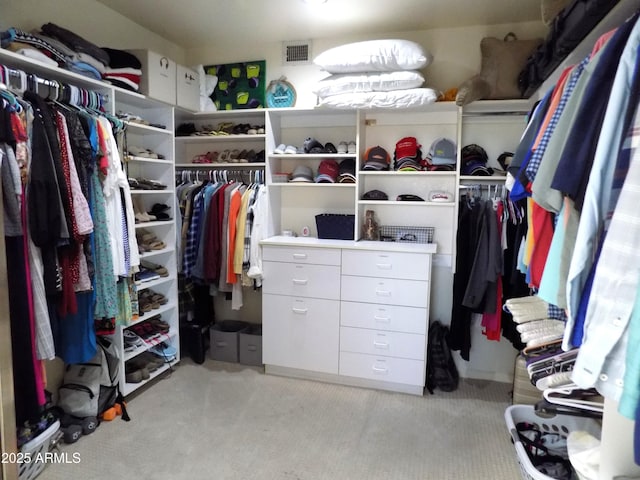 walk in closet with visible vents and light carpet