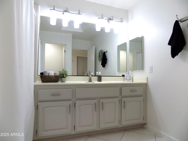 full bath with vanity, baseboards, and tile patterned floors