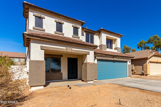 view of front facade featuring a garage, driveway, and stucco siding