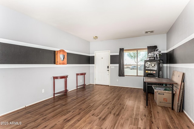 interior space with wood finished floors and visible vents