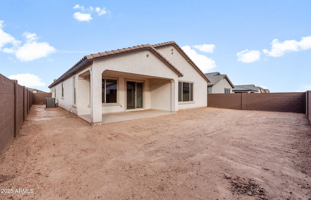 rear view of house with a patio and central AC unit