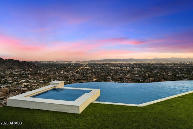 view of pool at dusk