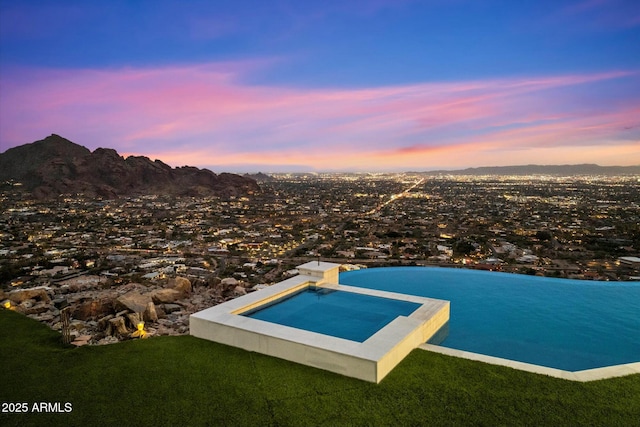 pool at dusk with a mountain view