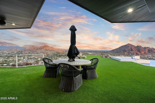 view of yard with a mountain view and outdoor dining area