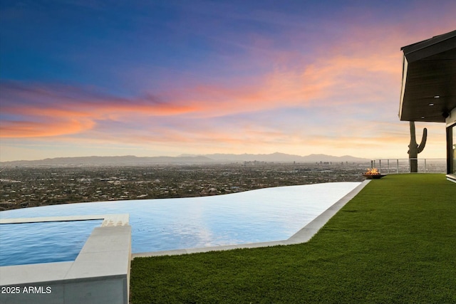 view of water feature with fence and a mountain view