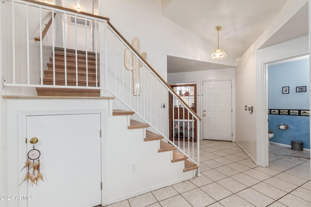 foyer featuring vaulted ceiling and light tile patterned floors