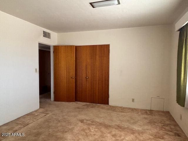 unfurnished bedroom with carpet floors and a closet