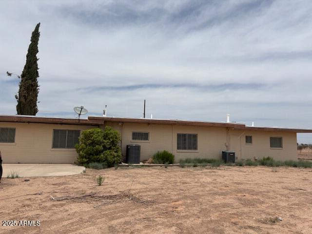 back of house with cooling unit and a patio