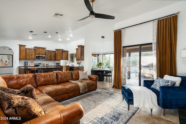 living room featuring ceiling fan, lofted ceiling, and sink