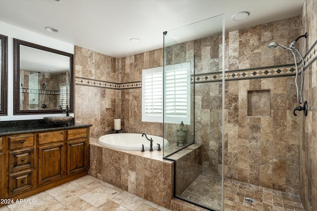 bathroom featuring vanity, tile walls, and plus walk in shower